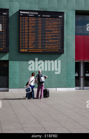 Exterior view of Tibertina Rail station in Rome. Couple looking at train timetable Stock Photo