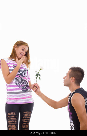 young man giving girl a white rose Stock Photo