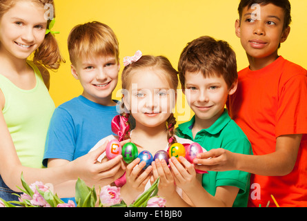 Five kids portrait who hold Eastern eggs Stock Photo