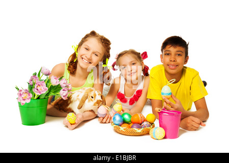 Three cheerful kids together with Eastern eggs Stock Photo