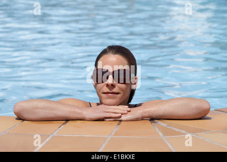 Woman relaxing in swimming pool, portrait Stock Photo - Alamy
