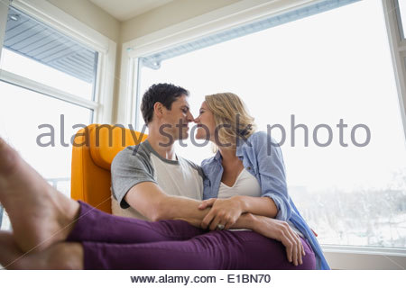 Couple rubbing noses in living room