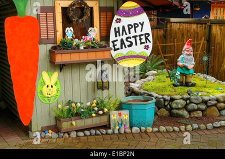 A whimsical front yard decorated for Easter with eggs and garden gnome. Stock Photo