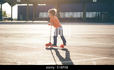 Little beautiful boy a scooter Stock Photo