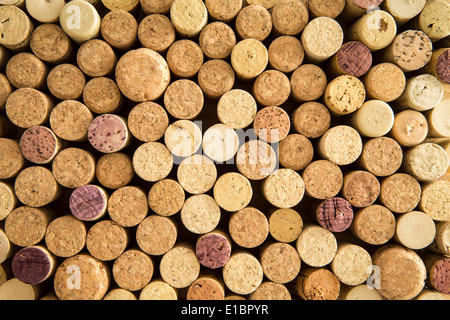 Background texture of neatly arranged corks from wine and champagne bottles packed tightly together with their tops facing up to Stock Photo