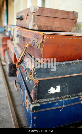 Stack of old suitcases at railway station Stock Photo