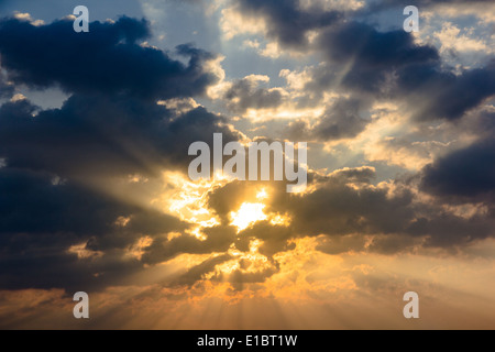Sunbeam ray light through cloud sky twilight color blue and orange Dramatic background Stock Photo
