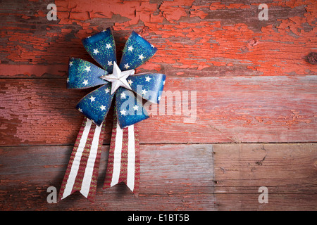 4th July patriotic badge in the form of a circular rosette with blue stars and a ribbon with the red and white stripes of the na Stock Photo