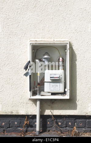 Doorless meter cupboard on exterior wall of house Stock Photo