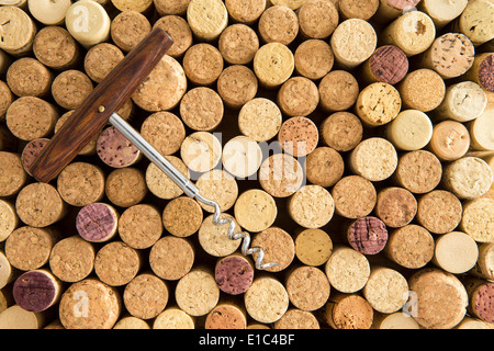 Background texture of neatly arranged corks and calassic wine bottle opener wine packed tightly together with their tops facing Stock Photo