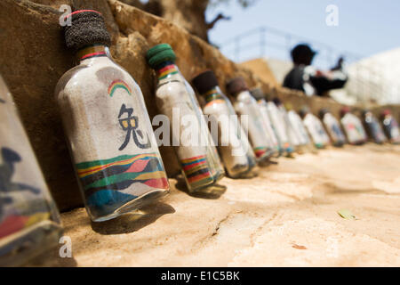 Dakar, Senegal. 24th May, 2014. Sand bottles made by artist Babacar Drame are seen at Ile de Goree in Dakar, capital of Senegal, May 24, 2014. The 11th edition of the Contemporary African Art Biennial, Dak'Art, is being held in Senegal from May 9 to June 8. Dakar is located on the Cap-Vert Peninsula on the Atlantic coast. Its position, on the western edge of Africa, is an advantage for the integration of the contemporary African art into the international art market. © Li Jing/Xinhua/Alamy Live News Stock Photo