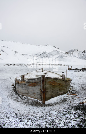 A wooden boat hull beached on Deception island, a former whaling station. Stock Photo