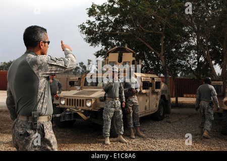 U.S. Army Sgt. Maj. Rafael Caraballo, left, assigned to the 6th Iraqi Army Division, Military Transition Team, receives verific Stock Photo