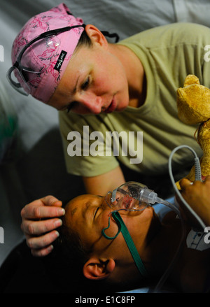 U.S. Army Staff Sgt. Virginia Andrews-Arce, a senior licensed practical nurse with the 541st Forward Surgical Team, comforts Ha Stock Photo