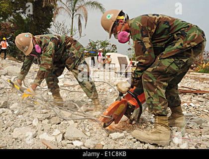 U.S. Sailors attached to Naval Mobile Construction Battalion (NMCB) 7 cut rebar during a search and recovery mission at the Hot Stock Photo