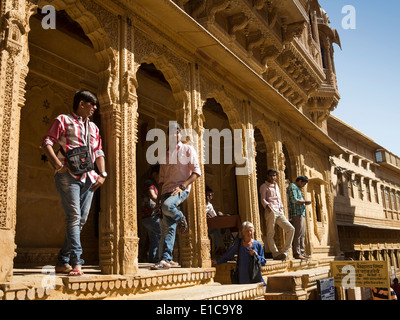 India, Rajasthan, Jaisalmer, Patwon Ki Haveli, Indian male tourists stood in archways Stock Photo