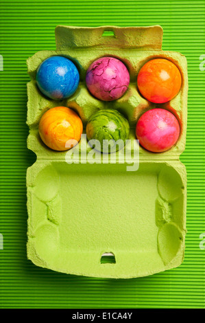 six colorful eggs in carton box Stock Photo