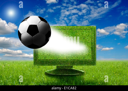 soccer ball coming out of a computer monitor Stock Photo
