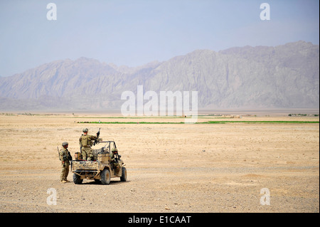 U.S. Soldiers provide security while members of the Farah Provincial Reconstruction Team conduct a quality assurance and qualit Stock Photo