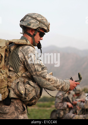 U.S. Army 2nd Lt. Matthew Meggs checks his compass to ensure his unit?s direction of travel during an air-assault mission in th Stock Photo