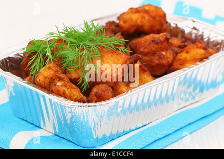 Fried cod pieces in take away tray Stock Photo