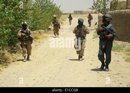 Afghan National Police officers conduct a patrol with U.S. Marines in the Helmand province of Afghanistan Aug. 3, 2009. The Mar Stock Photo