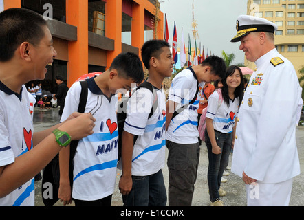 Chief of Naval Operations Adm. Gary Roughead, right, speaks with junior high school students during the Indonesian Internationa Stock Photo