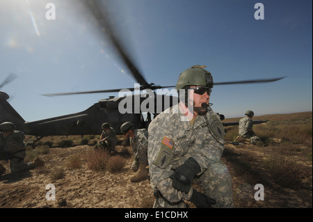 U.S. Soldiers from the Utah Army National Guard?s 19th Special Forces Group exit a U.S. Air Force HH-60 Pave Hawk helicopter at Stock Photo