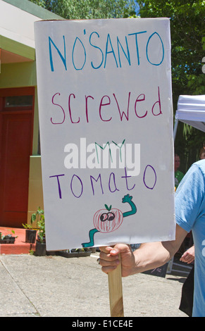 Asheville, NC, USA - May 24, 2014: Protester holds a humorous Monsanto sign at a GMO foods protest rally Stock Photo