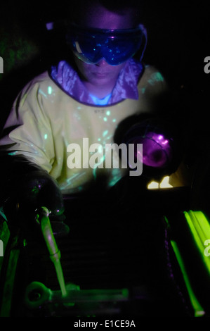 U.S. Air Force Staff Sgt. Richard Mabry uses a fluorescent particle bath and a black-light to inspect for cracks on an aircraft Stock Photo