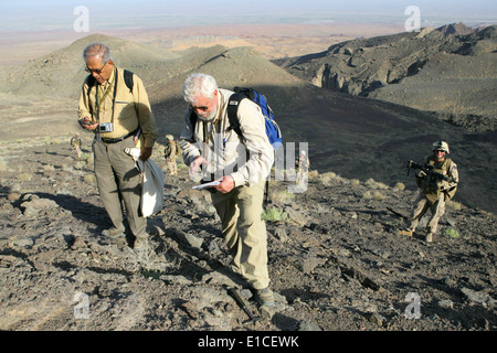 Steve Peters and Saidh Mirzad, both geologists with the U.S. Geological Survey, study abnormal rock formations during a site su