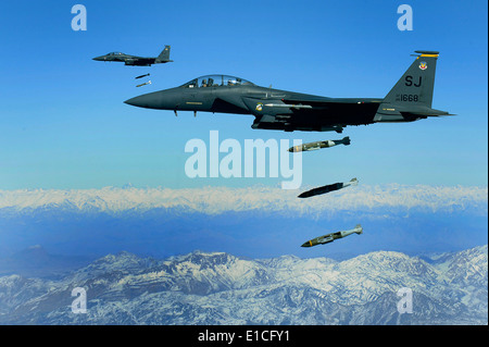 U.S. Air Force F-15E Strike Eagle aircraft from the 335th Fighter Squadron drop 2,000-pound joint direct attack munitions on a Stock Photo