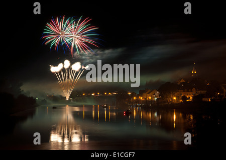 Fireworks over the river in a little town Stock Photo