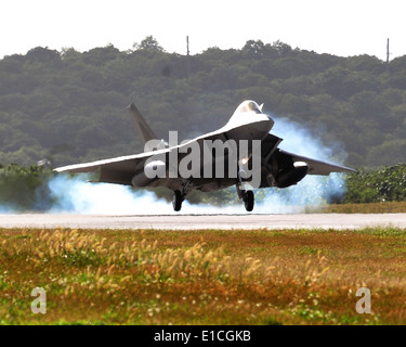 An F-22 Raptor aircraft assigned to the 90th Fighter Squadron out of Elmendorf Air Force Base, Alaska, lands on Andersen Air Fo Stock Photo