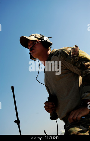 A U.S. Air Force combat controller conducts air traffic control operations at the Toussaint L?Ouverture International Airport i Stock Photo