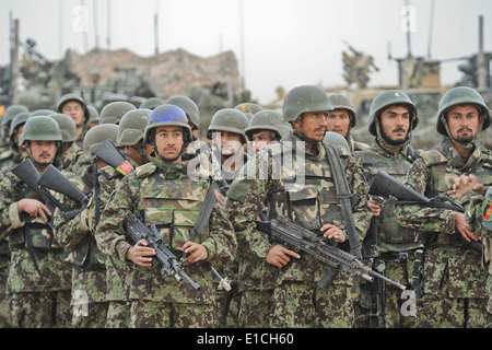 Afghan National Army stand in formation with flags during the national ...