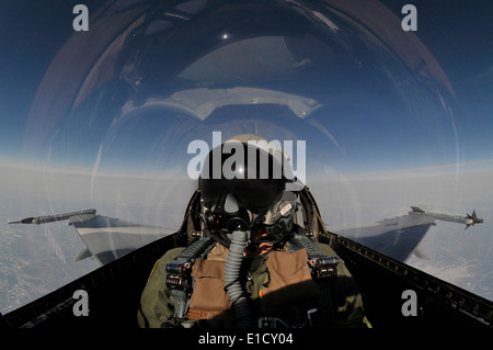 A U.S. Air Force pilot flies an F-16 Fighting Falcon aircraft, assigned to the 18th Aggressor Squadron, 354th Fighter Wing, ove Stock Photo