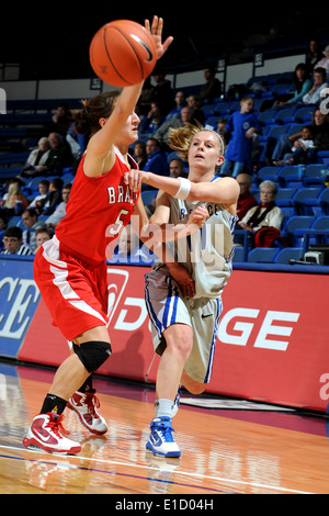 U.S. Air Force Academy sophomore guard Anna Gault passes the ball past Bradley University's Hanna Muegge, also a sophomore guar Stock Photo