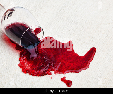 A glass of red wine was spilled on a carpet. Damage insurance. Stock Photo
