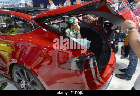 Leipzig, Germany. 31st May, 2014. A little girl sits in the trunk of a Tesla S at the Auto Mobil International 2014 (AMI) in Leipzig, Germany, 31 May 2014. The AMI car show runs from 31 May until 08 June 2014. Photo: HENDRIK SCHMIDT/dpa/Alamy Live News Stock Photo