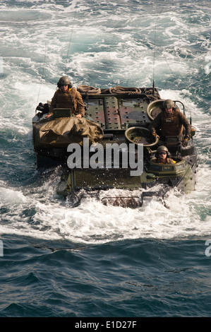 U.S. Marines from Special Purpose Marine Air Ground Task Force 24 transit the Pacific Ocean in an amphibious assault vehicle to Stock Photo