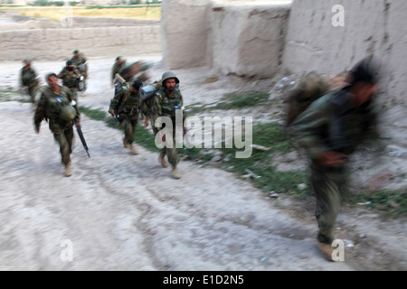 Afghan National Army soldiers move through a qalat during an operation in the in the Zormat district of the Paktya province of Stock Photo