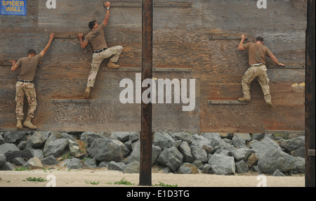 From left, U.S. Navy Yeoman 2nd Class Keenan Leftridge, Mass Communication Specialist 1st Class Anderson Bomjardin and Chief Ma Stock Photo