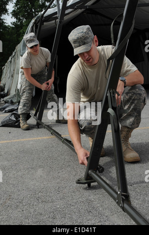 U.S. Air Force Staff Sgt. James Harrah, right, and Senior Airman Cassandra Brockway set up tents in preparation for an operatio Stock Photo