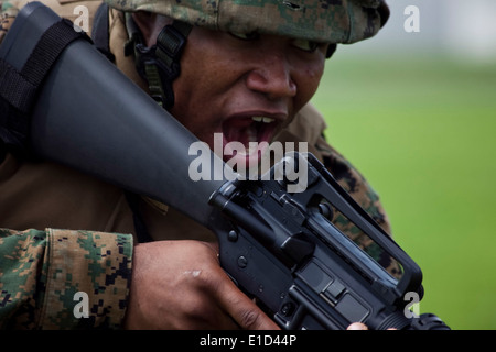 U.S. Marine Corps Lance Cpl. Robert Nichols shouts commands to his fire team leader as he prepares to rush during exercise Drag Stock Photo