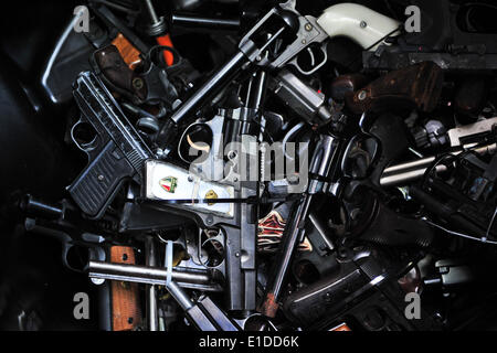 Los Angeles, USA. 31st May, 2014. Surrendered handguns are displayed at a gun buyback event in Los Angeles, the United States, on May 31, 2014. People can exchange their firearms at four Los Angles-area locations for supermarket gift cards. The Citywide Gun Buyback Program first took place in Los Angles in 2009 and was held by the Mayor's Office of the Gang Reduction and Youth Development (GRYD) to reduce the number of guns on the streets. More than 12,000 guns have been bought back and destoryed in the past five years. Credit:  Zhang Chaoqun/Xinhua/Alamy Live News Stock Photo