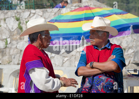 Two Tzotzil Indian men wearing traditional clothes Sunday market San Lorenzo Zinacantan Village Chiapas Mexico Stock Photo