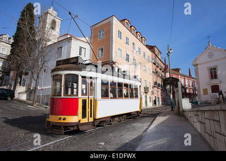 Historic tram nr 28 on a street of Alfama district in the city of Lisbon in Portugal. Stock Photo