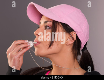 Lady blows star studded whistle Stock Photo