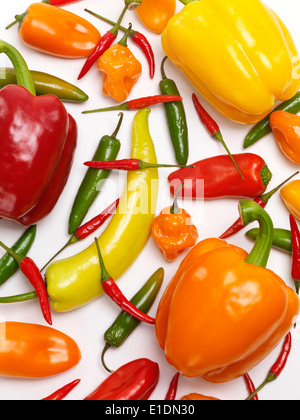 Variety of sweet and hot peppers, colorful food background. Red, yellow, orange sweet peppers, Jalapeno, Cubanelle, Thai peppers Stock Photo